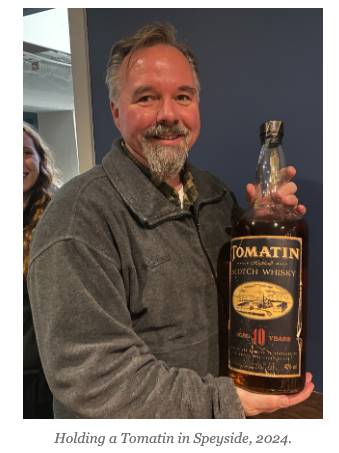Holding a Tomatin in Speyside, 2024.